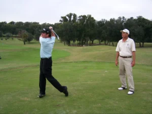a man practicing golf with his instructor behind | Golf For Beginners | Northbridge Golf Club