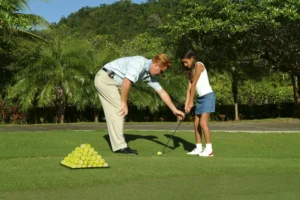 image of man teaching a girl golf